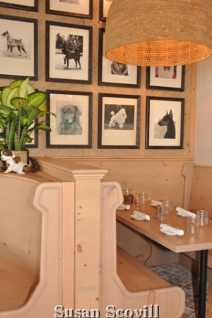 The restaurant is decked out to the K9s, the Garden Room has a brick floor, and hanging baskets with Edison bulbs. The room also has original prints of “best in show dogs” from the 1940s. The Living Room has handmade brass dog-shaped sconces on the walls, black marble tables, and a large working fireplace.Known for the warm hospitality and creative, inspiring cuisine, the