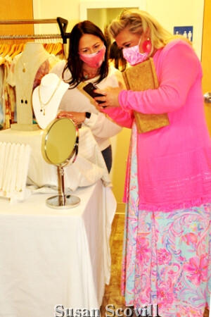 8. Megan Boyle (right) consulted Kathy Romano (left) about her jewelry purchase.