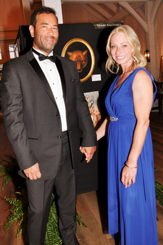 13. Brian and Luiza Malloy examined the art exhibit and auction items that were available at the fundraiser.