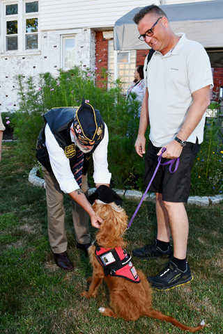 4. Past Commander Scott Carlson greeted Tails of Honor Puppy, Barney a Lapradoodle puppy, and Brian Hausknecht during the event