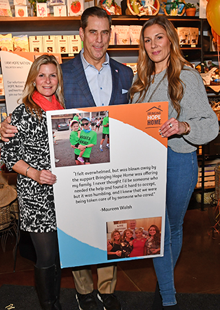 2. Suzy,Pratowski Bringing Hope Home CEO Paul Isenberg and Ashley Dunek of Philly Man New Jersey paused for a photo with Bringing Hope Home Banner during the fundraiser at DiBruno’s . Suzy won Philly Man’s Unmasking Award during its annual gala in 2022 and donated the proceeds from that event to Bringing Hope Home!