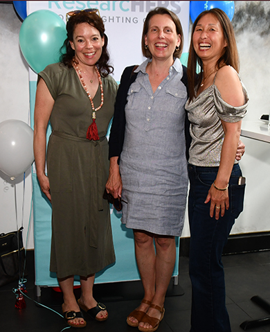 12. Molly Duffy and Cecilia Chang chatted wuth a event attendee (left)
