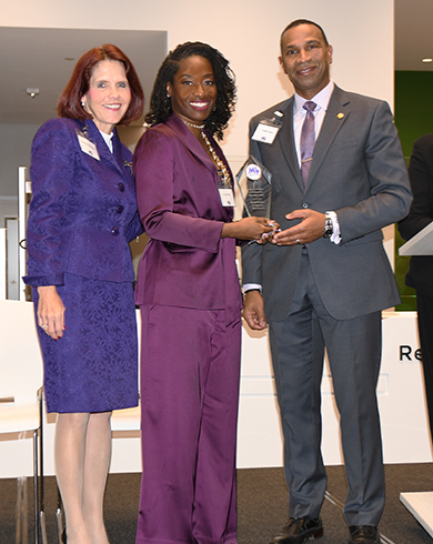Dr, Seun Ross receied her award from the event co-chairs