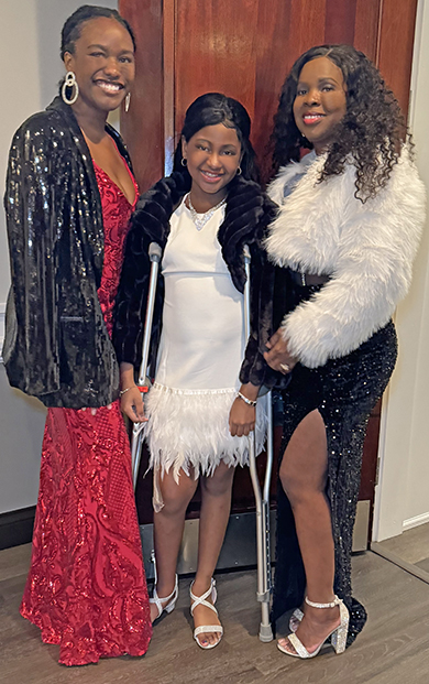 Anijah Brown (center) with Anna Brown and Teyler Wilson, modeled during the fashion show.