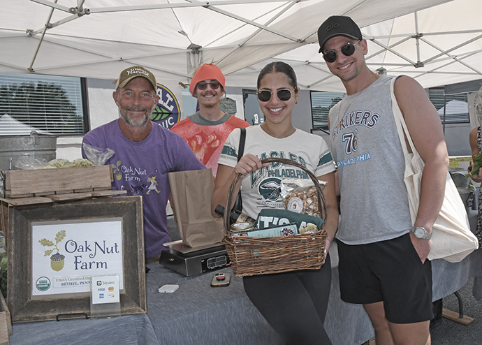 6. Sean McDernott of Oak Nut Farm brought his culinary harvest product to the event. "Tomato Guy, " Vlad Puskovitch joined Lizzy Friedman and Joshua Freed in a photo ''op'' as they made their purchases!
